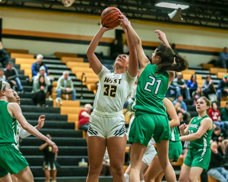 Joliet West's Brooke Schwall (32) puts up a shot under the basket during basketball game between Providence Catholic at Joliet West. Dec 18, 2023.