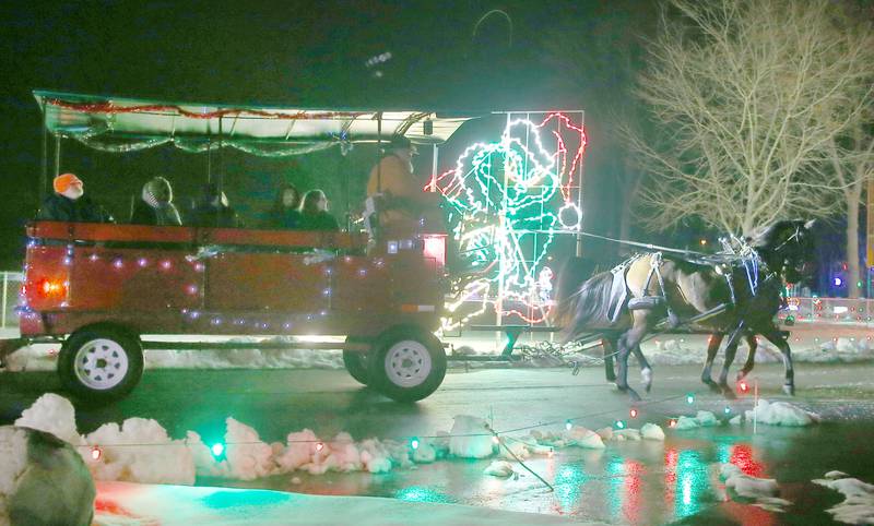 Tony Troyer of Arabian Carriage Co. leads a team of horses through the Christmas lights on Tuesday, Rotary Park on Tuesday, Dec. 9, 2025 in La Salle. Carriage rides are offered in November and December at Rotary Park. The last ride is scheduled for Thursday, Dec. 11. Prices are $25 per person or $200 for the entire wagon up to a dozen people. The carriage rides are orginazed by the Illinois Valley Chamber of Commerce. For more information visit https://www.ivaced.org/carriage-rides.