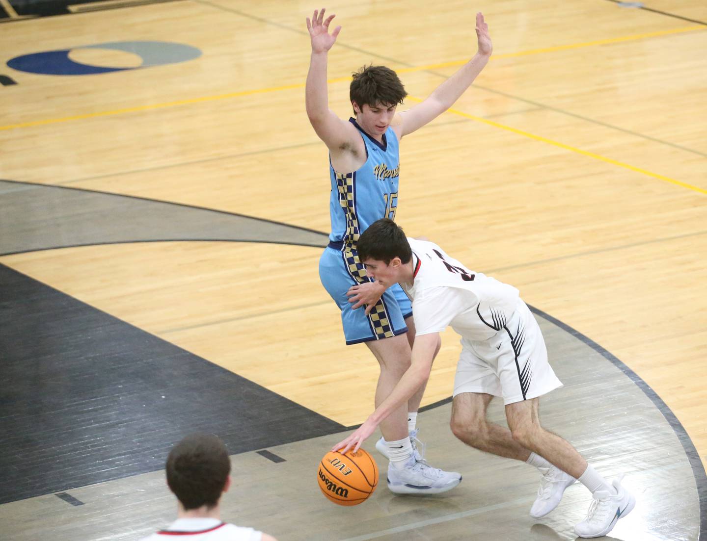 Woodland's Nick Plesko gets by Marquette's Alec Novotney to run into the lane during the Tri-County Conference Tournament on Tuesday, Jan. 28. 2025 at Putnam County High School.
