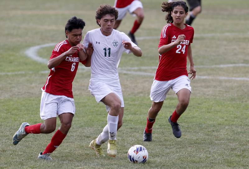 Dundee-Crown's Jonathan Troncoso tries to push Crystal Lake South's Nico Velasco of the ball as Dundee-Crown's Sebastian Sanchez races to help his teammate during a Fox Valley Conference soccer match Tuesday, Sept. 5, 2023, at Dundee-Crown High School in Carpentersville.