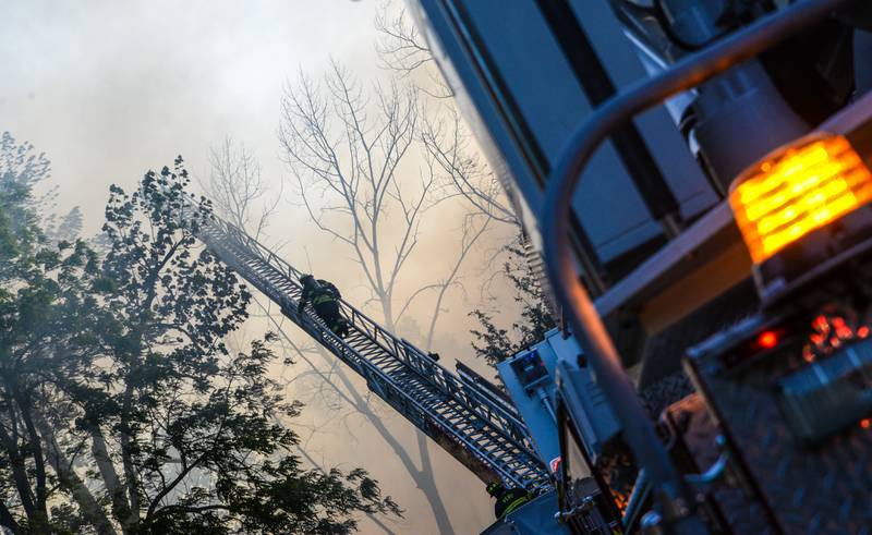 An aerial ladder truck at the scene of the multi-unit fire Monday, May 30, 2022, at Grand Bear Resort in Utica.