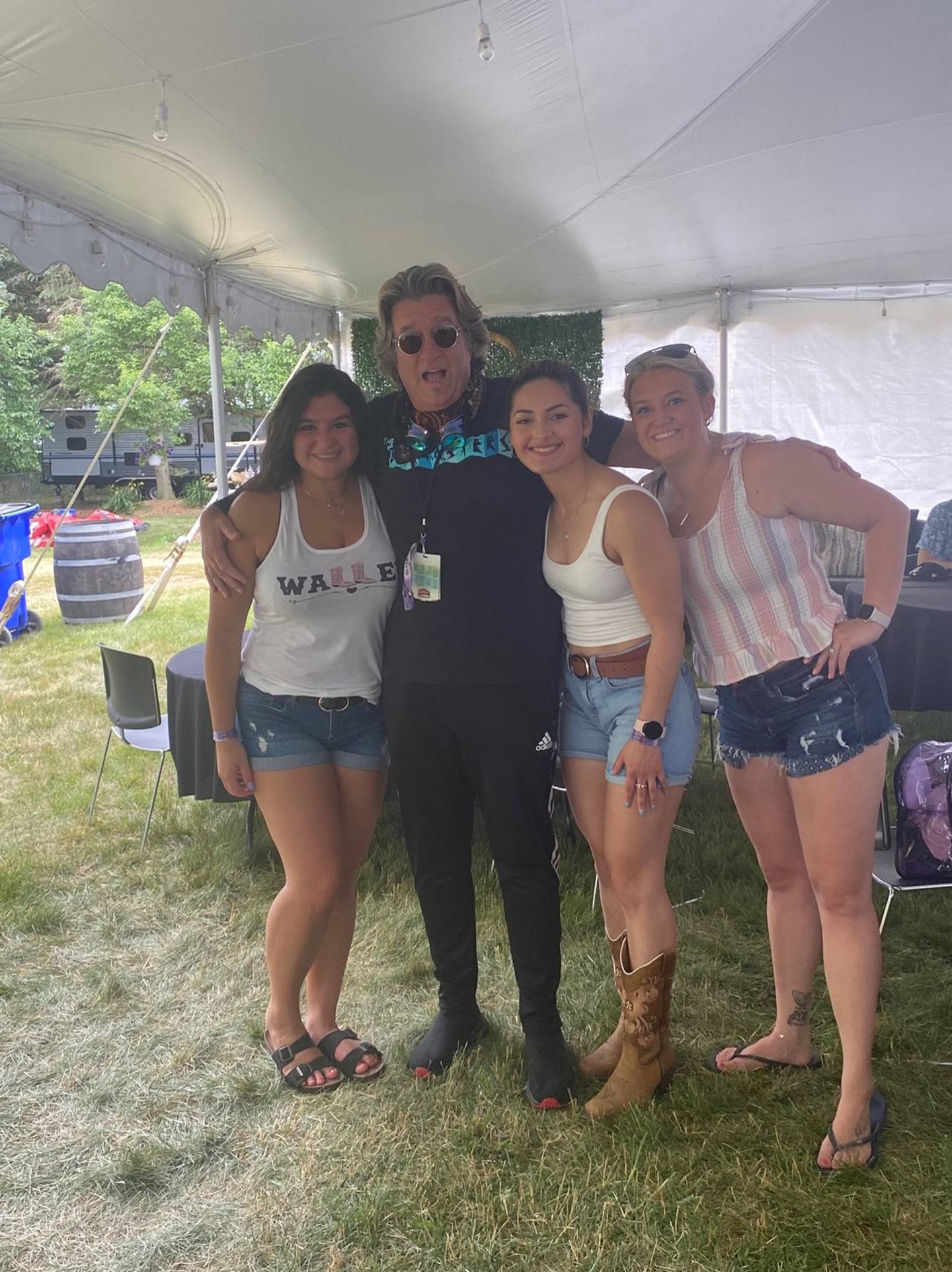 Alexa Duenas, of Woodstock, Bruce Williams, of Nashville, Tennessee, Jessica Ochoa, of Crystal Lake, and Brea Jereb, formally, of Lake in the Hills, at Country Thunder in Twin Lakes Wisconsin July 23, 2022. Williams was a patient in the emergency room at Northwestern Medicine-McHenry, where Duenas works as an ER nurse. Duenas cared for him on July 22 and to repay her, Williams, a performer and emcee for Country Thunder, surprised her and two friends with upgrading their general admission tickets to VIP.