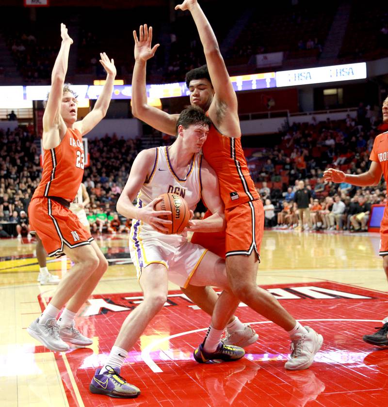 Downers Grove North’s Jake Riemer (center) tries to find an opening against the Normal Community defense during the Class 4A Normal Supersectional game on Monday, March 4, 2024.