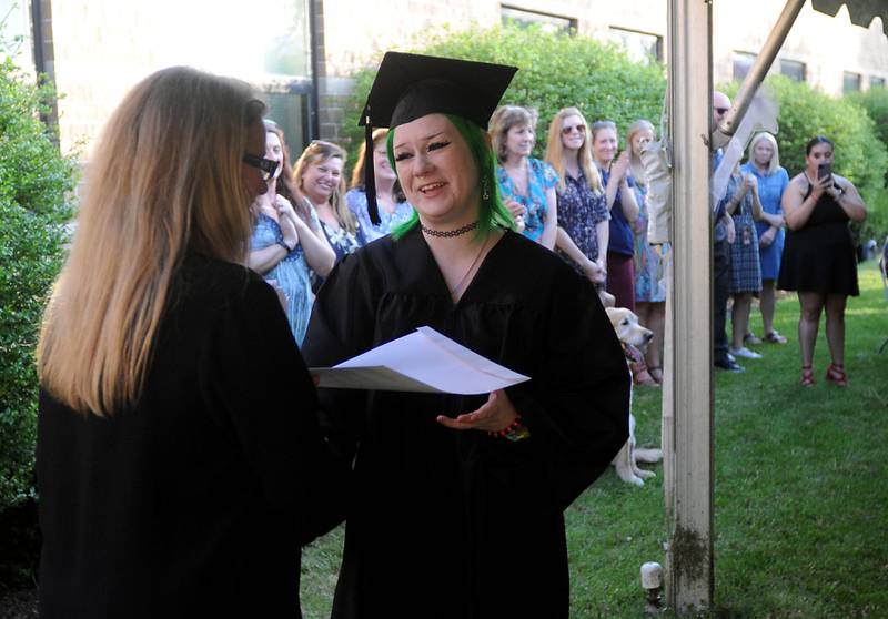 Julie Duncan, administrator of Haber Oaks Campus, hands Payton Jones her diploma Thursday, May 12, 2022, during the Haber Oaks Campus graduation in the courtyard of Crystal Lake South High School.