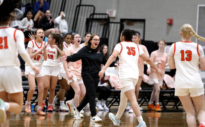 St. Charles East's head coach Katie Claussner congratulates her team between quarters during a game against Wheaton Warrenville South on Tuesday, Feb. 11, 2025 in St. Charles.