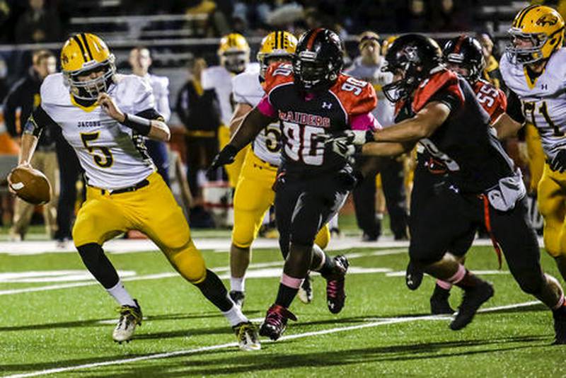 Jacobs' quarterback Bret Mooney runs the ball during the first quarter of a game against Huntley at Huntley High School in Huntley, Ill. on Friday, Oct. 18, 2013. Jacobs defeated Huntley 27-20.