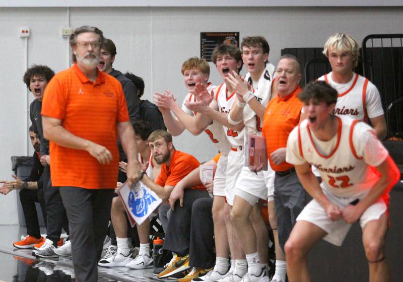 McHenry’s Head Coach Corky Card and the Warriors get revved up as they rally in the second quarter against Burlington Central in varsity boys basketball on Friday, Dec. 5, 2025, at McHenry Community High School in McHenry.