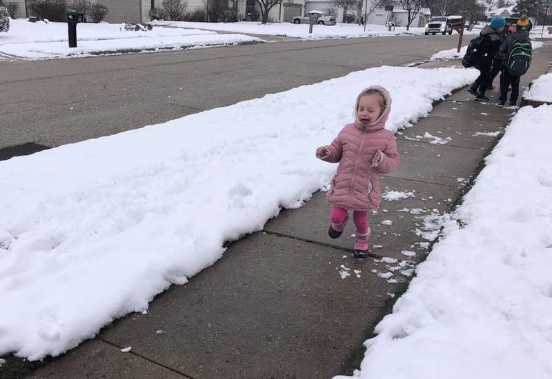 Emma Jaglowski, 4, of McHenry enjoys the wintry weather -- that fell in spring -- on March 22, 2024.