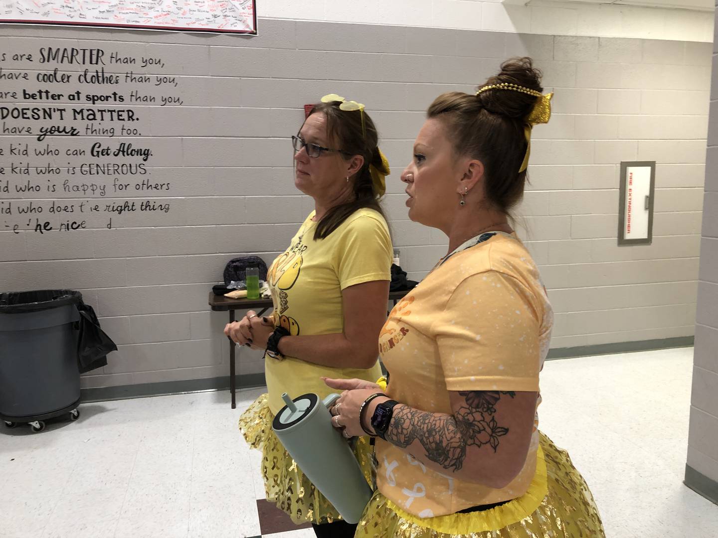 Teachers, students and staff at McHenry Middle School wore gold on Thursday, Sept. 25, 2025, for childhood cancer awareness month, including Angie Ingrassia, left, and Nicole Peterson. Peterson's son was diagnosed with a form of leukemia in 2023, making it the campaign personal for her.