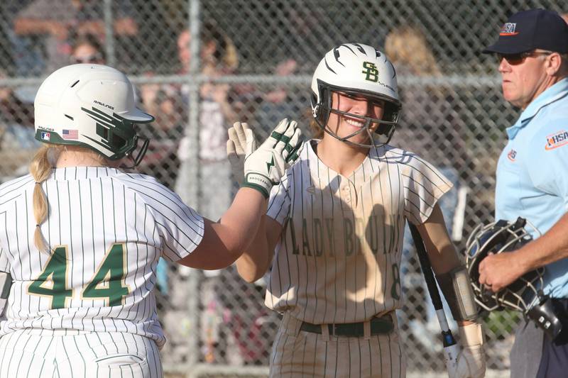 St. Bede's Lily Bosnich hi-fives teammate Macy Strauch after scoring a run against Illinois Valley Central during the Class 2A Regional final on Friday, May 23, 2025 at St. Bede Academy.