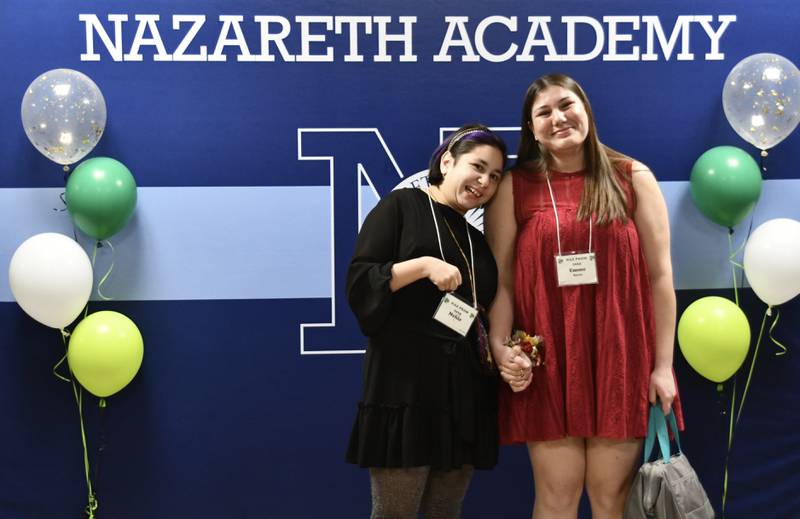 Nehir and her buddy Emme Barnes stop for an official FISH Prom portrait during the 7th FISH Prom for Teens with Disabilities on Saturday, March 8, 2025 at Nazareth Academy in La Grange Park.