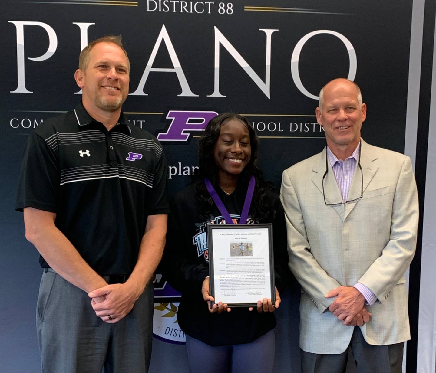 Pictured from left are Plano School District Superintendent Tony Baker, PHS junior Armoney Clay and PHS head girls track coach Rick Ponx.