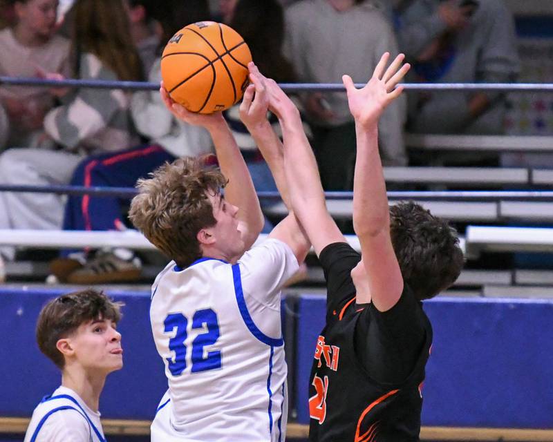 Wheaton North's Ben Gillmar (32) makes a shot while being defended by Wheaton Warrenville South's David Showman (23) during the game on Friday Feb. 6, 2026, held at Wheaton North High School