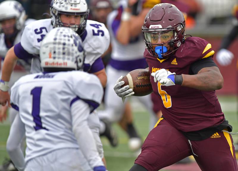 Montini power back Jeremiah Peterson confronts Wilmington's William Moore (1) during a Class 3A semifinal game on November 23, 2024 at Montini Catholic High School in Lombard.
