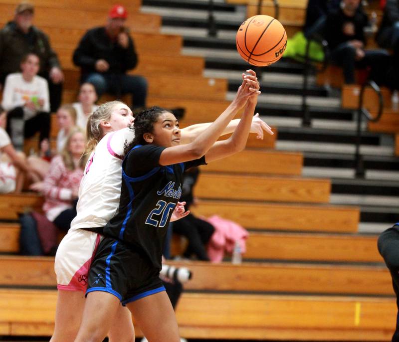 St. Charles North’s Sydney Johnson reaches for a rebound during a game against Batavia on Monday, Dec. 16, 2024 in Batavia.