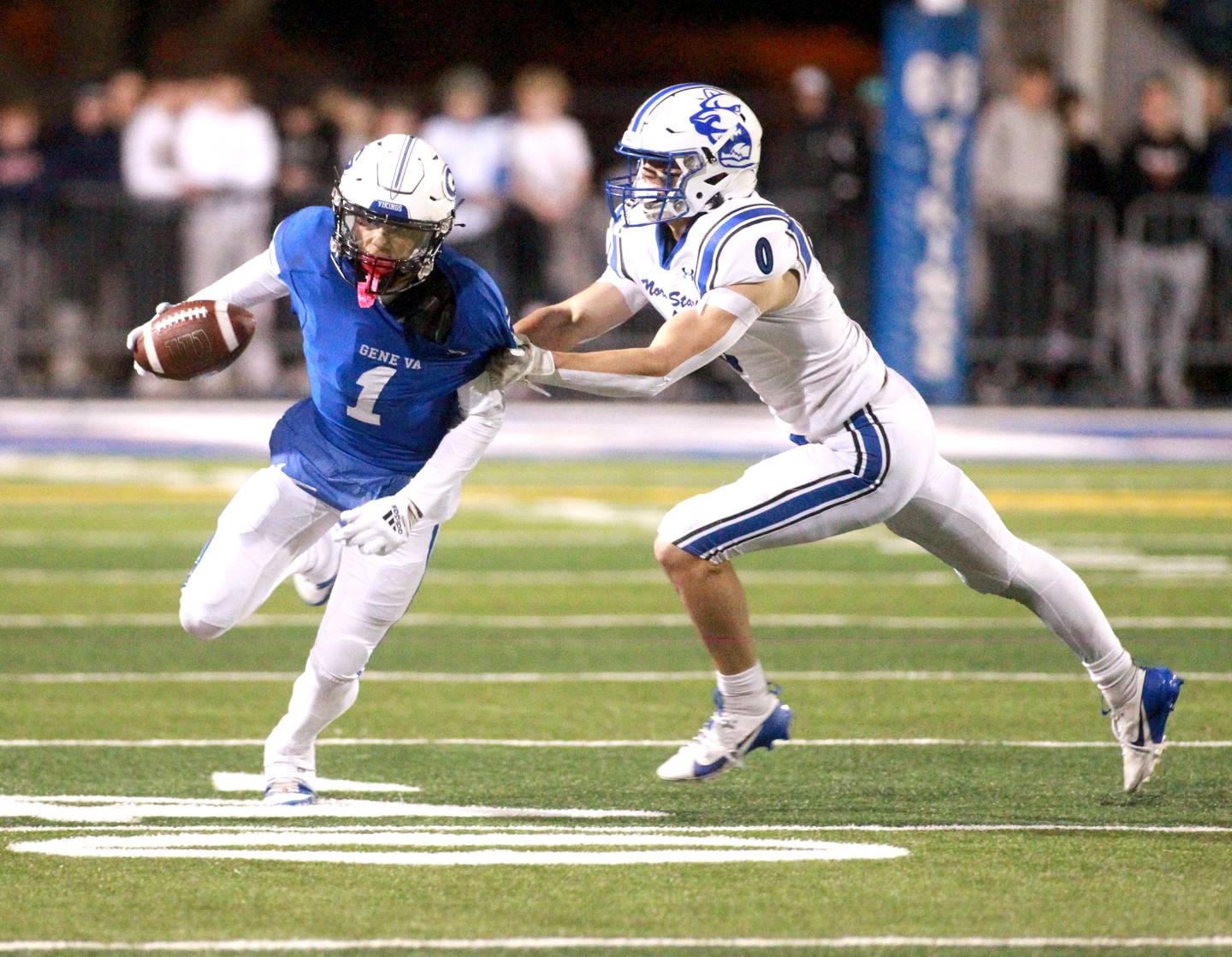 Geneva’s Talyn Taylor carries the ball as he’s tackled by St. Charles North’s Aidan McClure on Friday, Oct. 25, 2024 during a game at Geneva.
