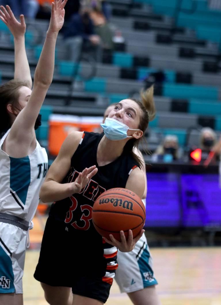Crystal Lake Central’s Kathryn Hamill navigates through traffic during varsity girls basketball at Woodstock North Monday night.