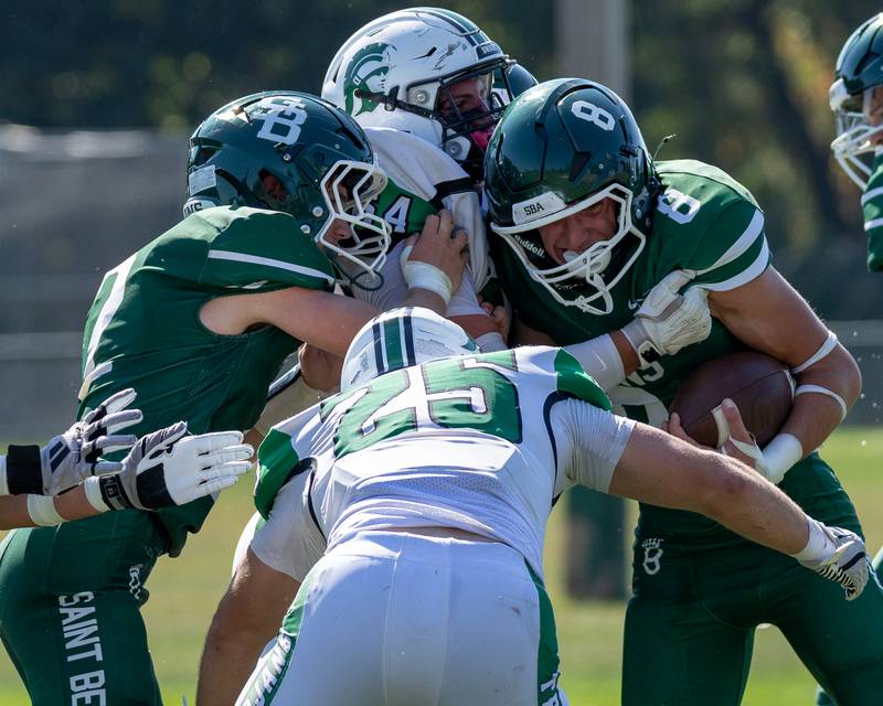 Gino Ferrari (8) of St. Bede attempts to run ball as he is held by Will Anderson (64) and Ayden Collom (25) of Dwight on Saturday, Oct. 4, 2025 at Captain Thomas J. Heitmann field in Peru.
