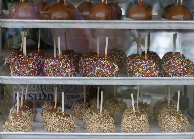 Candy apples are for sale Friday, July 1, 2022, during Lakeside Festival at the Dole and Lakeside Arts Park, 401 Country Club Road in Crystal Lake. The festival continues noon to 11 p.m. July 2 and noon to 10 p.m. July 3. The festival features bands on two outdoor stages, food and drinks, a baggo tournament, and carnival rides and games. Among the activities for kids are face painting, a balloon twister, a stilt walker, team mascots and a magician.