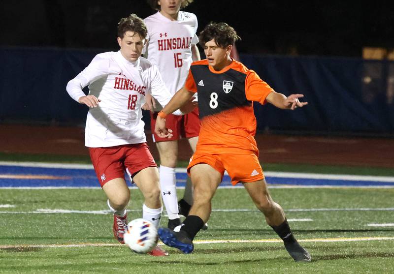 Hersey's Teddy Reyes kicks the ball away from Hinsdale Central's Austen Szurgot Friday, Nov. 8, 2024, during their Class 3A state semifinal game at Hoffman Estates High School.
