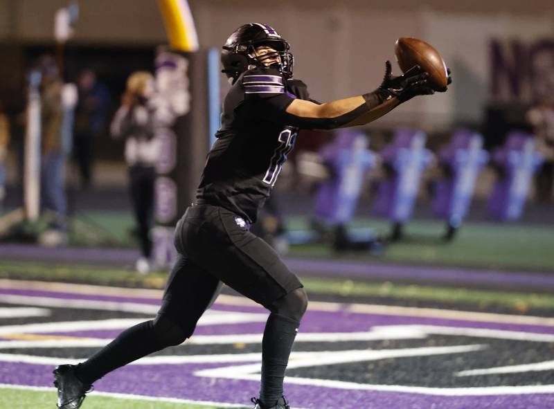 Downers Grove North's Charlie Cruse (11) makes a catch for a touchdown during the 7A first-round playoff game between Wheaton Warrenville South and Downers Grove North high schools on Friday, Nov. 1, 2024 in Downers Grove.