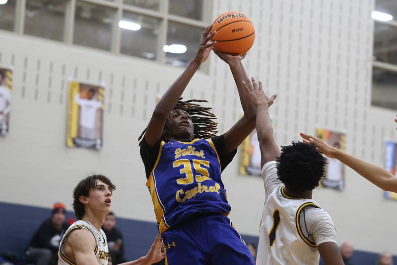 Joliet Central’s REvell Gilbert puts up the contested shot against Joliet Catholic on Tuesday, Jan 20, 2026 in Joliet.