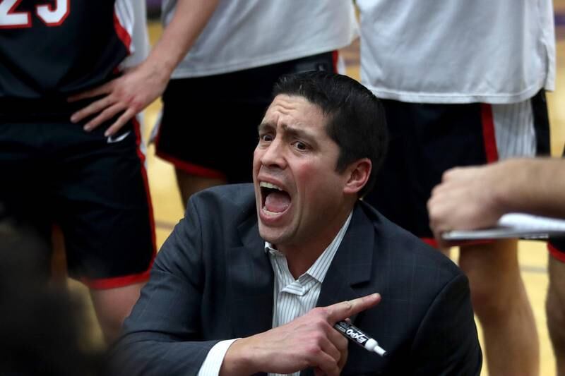 Huntley’s coach Will Benson works with the Red Raiders during a time out in boys basketball at Hampshire on Friday.