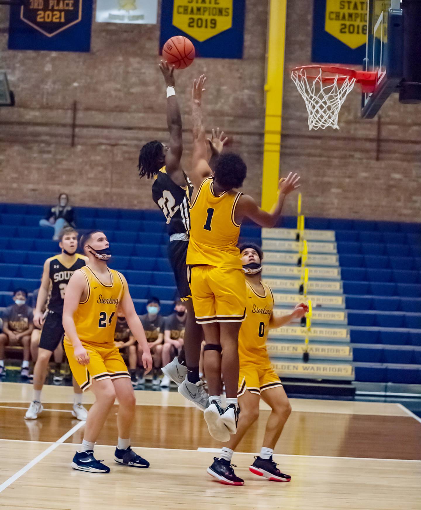 Hinsdale South's Cassidy Whitaker shoots over Sterling's Tyree Kelly (1) during their Sterling MLK tournament game Saturday evening at Musgrove Fieldhouse.