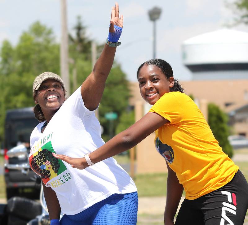 Temeka Booker and her daughter Zoey Bishop, 12, from Zoomba By Temeka in Naperville, run a class Saturday afternoon during a Juneteenth celebration near the site of the old Campus Cinema building in DeKalb. The event was sponsored by New Hope Missionary Baptist Church, the NIU Center for Black Studies and B.L.L.A.C.K. Inc. NFP.