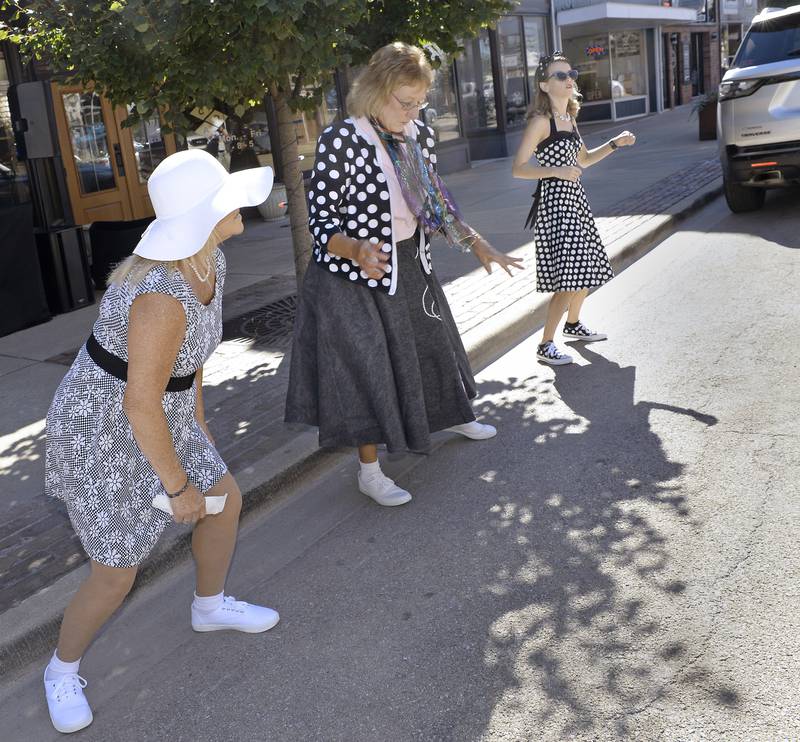 Dressed in their 50Õs finest, Brenda Stimpert, Patty Long and Rebecca Neaterhour dance the afternoon away Friday along Main St. in Streator during a special Cruise Night Eve in the downtown area.