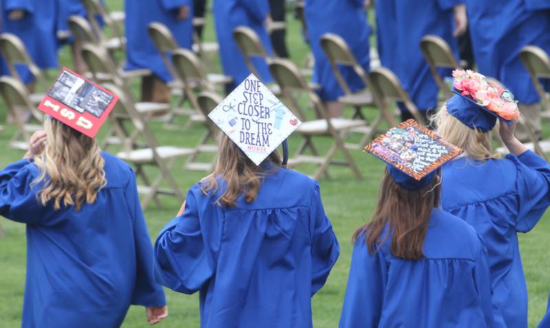 Princeton High School graduates walk in procession while wearing decorated caps during the 156th annual Commencement on Saturday, May 17, 2025 at Bryant Field.