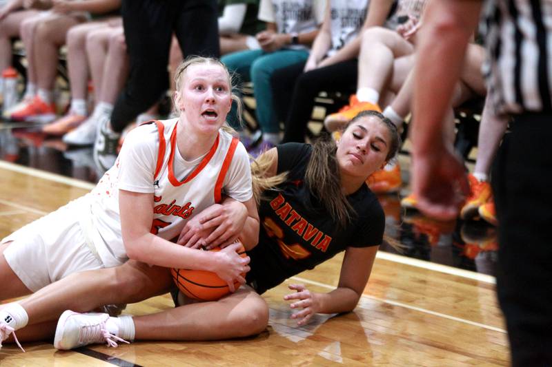 St. Charles East’s Brooklyn Schilb (left) and Batavia’s Hallie Crane battle for a jump ball during a game on Wednesday, Jan. 8, 2025 in St. Charles.