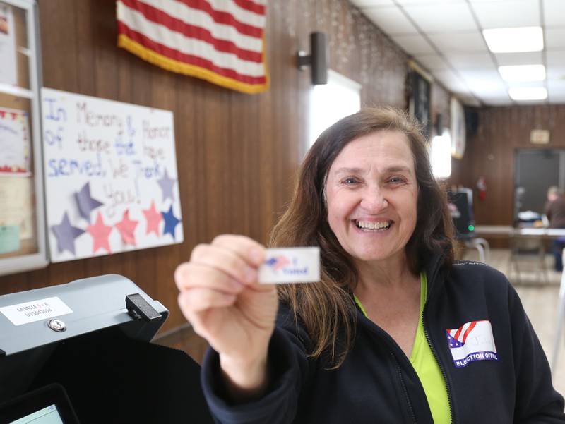 Election judge Julie Bleck, poses with an "I voted" sticker on Tuesday, April 1, 2025 at the La Salle VFW.