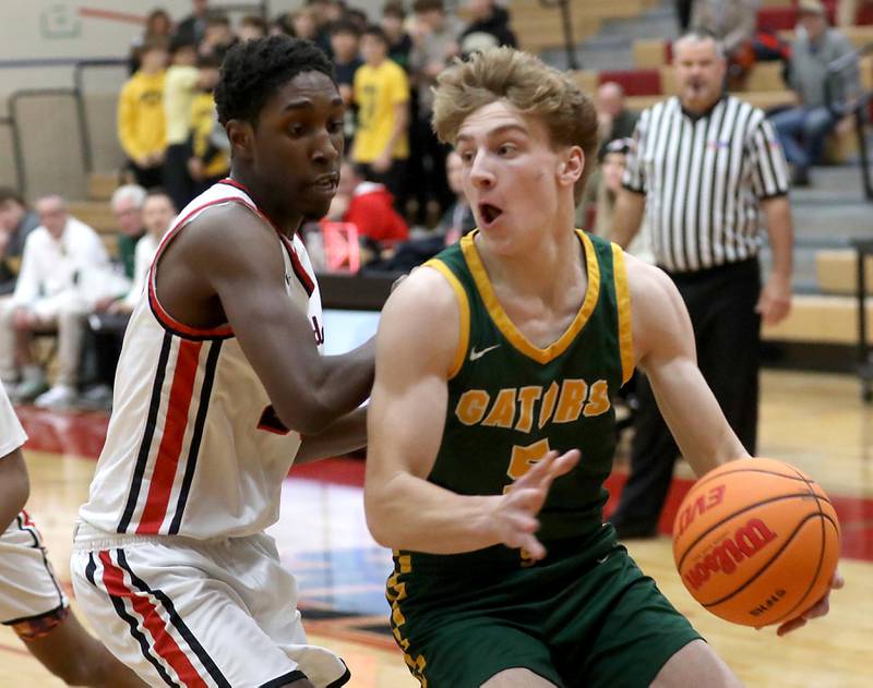 Crystal Lake South's Carson Trivellini (right) drives to the basket against Huntley's Isaiah Onu during a Fox Valley Conference boys basketball game on Wednesday, Dec. 10, 2025, at Huntley High School.
