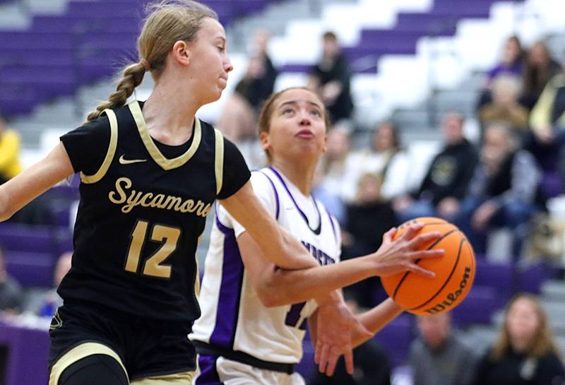 Hampshire’s Mikala Amegasse, right, drives against Sycamore’s Sadie Lang in varsity girls basketball on Friday, Jan. 3, 2025, at Hampshire High School in Hampshire.
