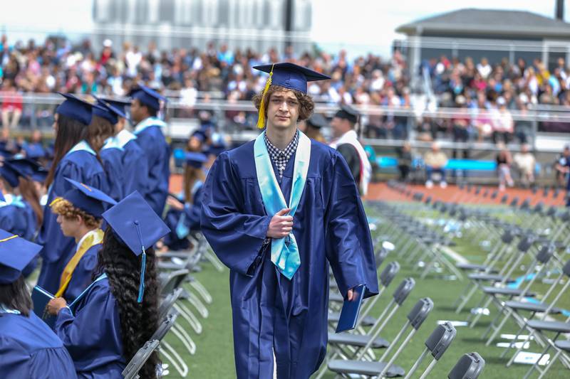Graduands return to their seats after receiving their diplomas during the Downers Grove North graduation ceremony at the school on Sunday, May 22, 2022