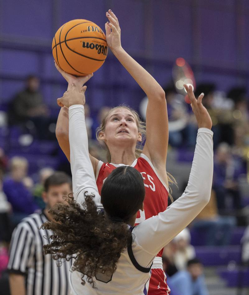 Ottawa’s Hailey Larsen puts up a shot against Dixon’s Ahmyrie McGowan Wednesday, Dec. 4, 2024, at Dixon High School.