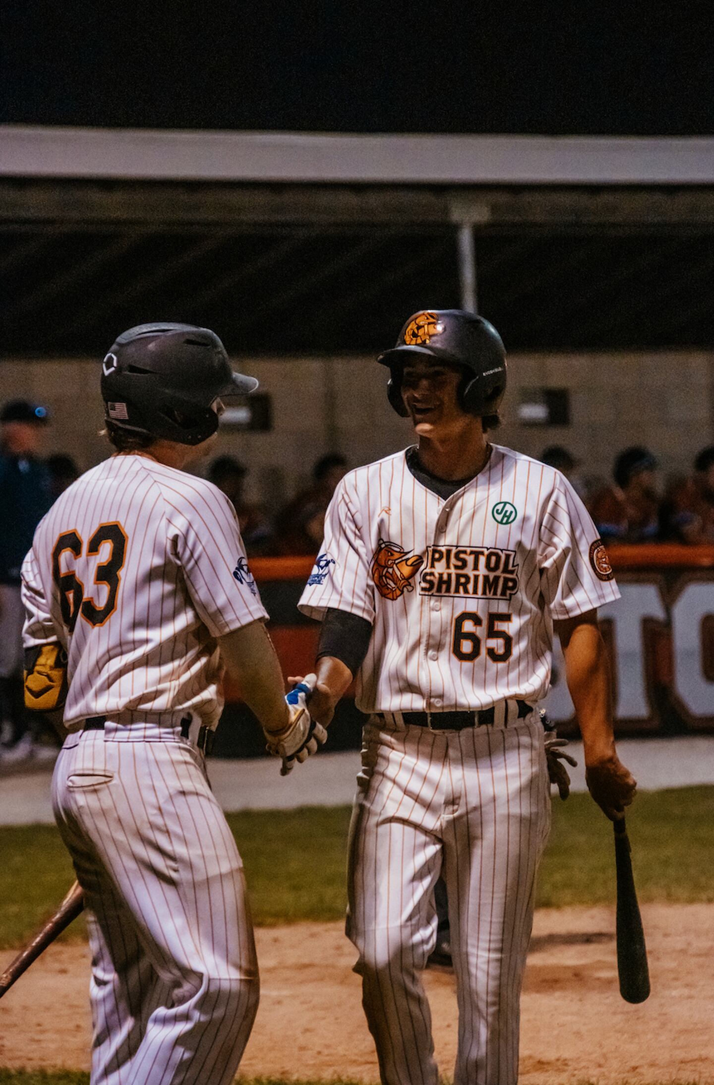 Jack Johnston (63) and Kyle Gibson high five during the Illinois Valley Pistol Shirmp's 9-8 loss to the Springfield Lucky Horseshoes on Friday, June 21, 2024 at Schweickert Stadium in Peru.