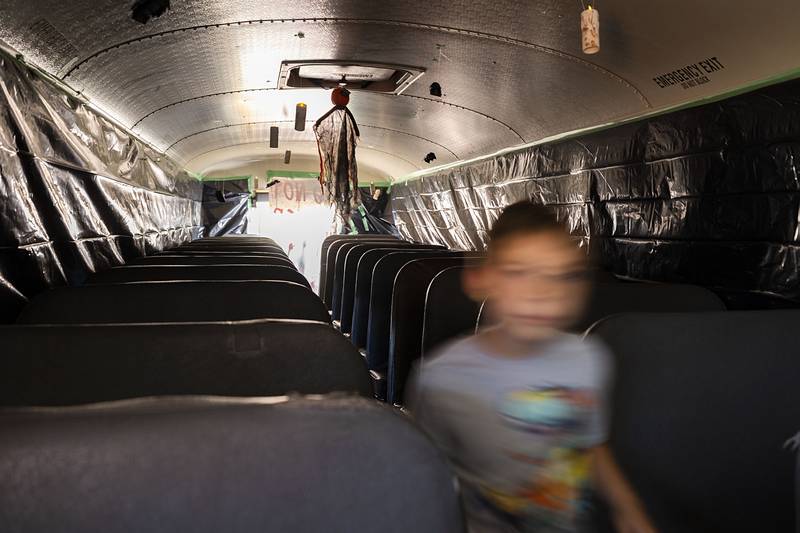 The ghostly figure of Nathan Payne, 7, of Sterling is seen wandering the haunted school bus at First Student transportation Saturday, Oct. 22, 2022. The Rock Falls bus company held their first Halloween celebration with games, candy, the haunted bus tour and a costume contest.