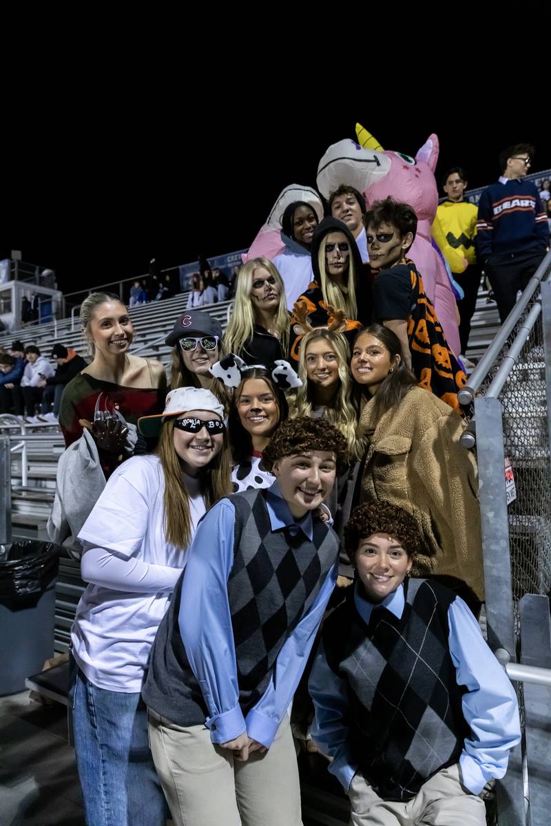 Lincoln-Way East’s super-fans take a Halloween photo prior to a varsity football round one playoff game against Stevenson at Lincoln-Way East on Oct. 31, 2025.