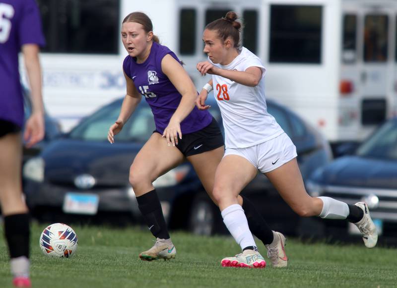 Hampshire’s Sydney Hedderich, left, and Crystal Lake Central’s Jillian Mueller race for the ball in varsity soccer at Hampshire Tuesday evening.