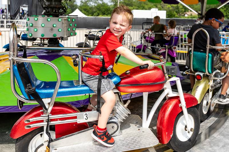 Three-year-old Lockport resident Myles Lestarczyk enjoys a motorcycle ride during Old Canal Days in Lockport on June, 7, 2025.