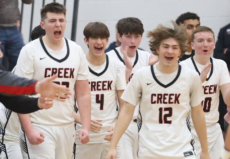 Members of the Indian Creek boys basketball team react after defeating Woodland during the Class 1A Sectional Semifinal game on Wednesday, March 4, 2026 at Amboy High School.
