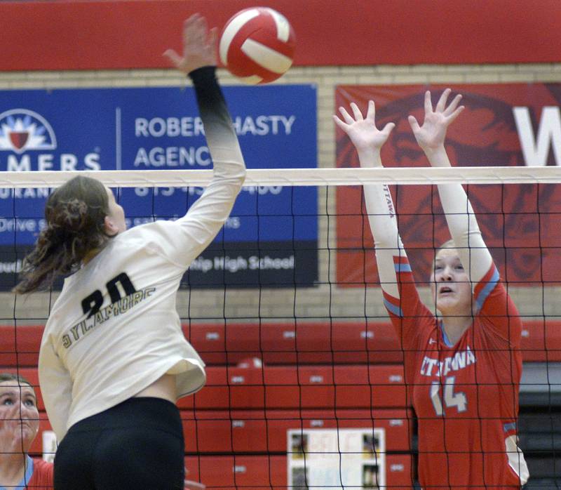 Ottawa’s Libby Muffler prepares a block attempt from Sycamore’s Ava Wente-Argo  in the 1st set of Tuesday’s match at Ottawa.