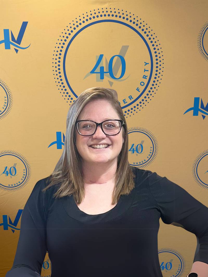 Rachel Black poses for a photo underneath the 40 Under Forty backdrop.