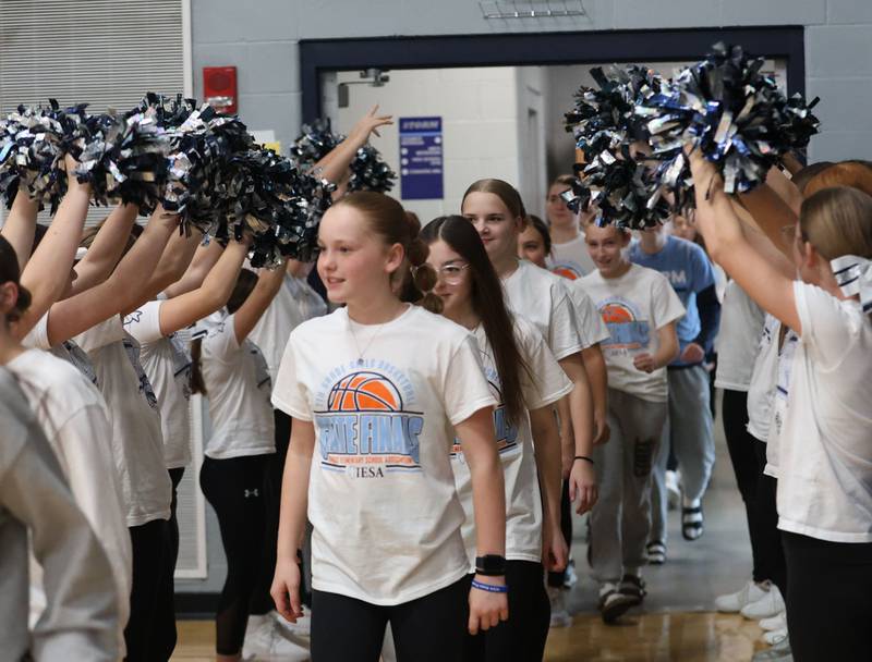 Members of the Bureau Valley Storm seventh-grade girls basketball team enter the gym during a prep rally on Thursday, Dec. 11, 2025 at Bureau Valley High School in Manlius. The Storm (23-1) will meet undefeated Mt. Sterling Brown County (25-0) for the IESA Class 2A state title at 7:30 p.m tonight.