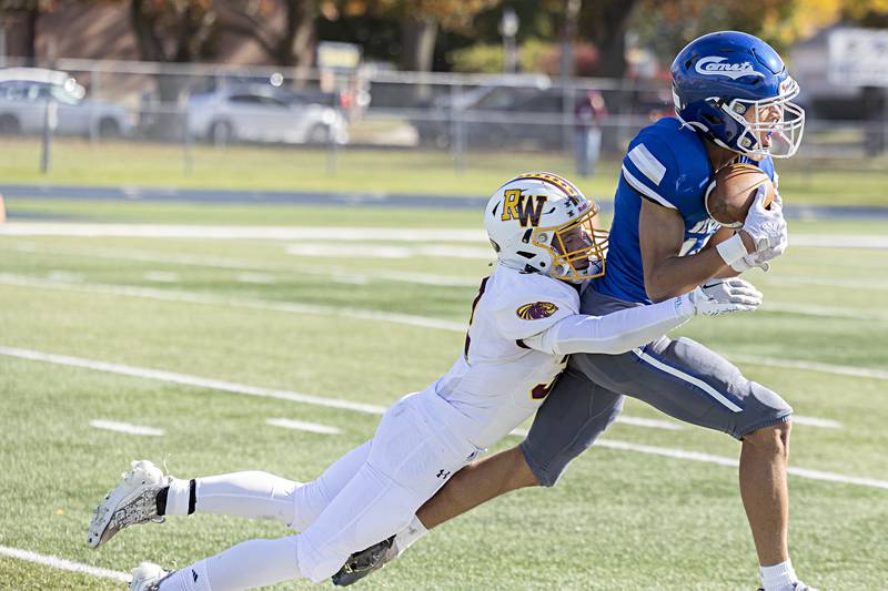 Newman’s Isaiah Williams is hauled down by ROWVA’s Jack Cordle after a catch Saturday, Oct. 28, 2023 in the Class 1A playoffs in Sterling.