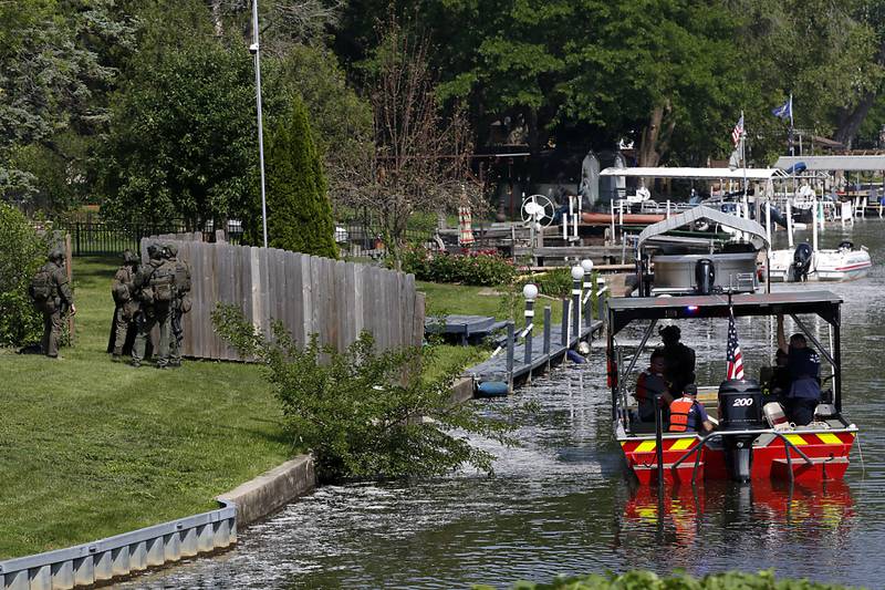 Law enforcement from area departments surround a home on Thursday, June 5, 2025, in the area of Venice Avenue and Court Street in McHenry.