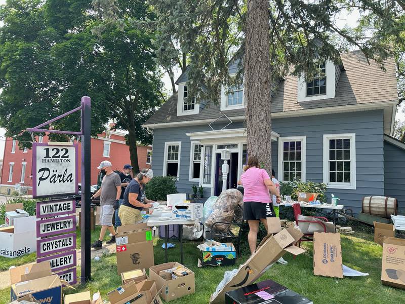 Volunteers from the Geneva business community assist in the clean up after a fire Monday, July 22, at a retail store, Pärla, 122 Hamilton St., Geneva.