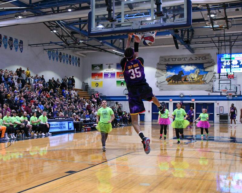 Harlem Wizard player Sky-Rise dunks the ball during the game against the Downers Grove Staff on Sunday Jan. 19, 2025, held at Downers Grove South High School.